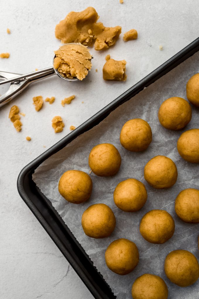 Cake pop balls on a baking sheet.
