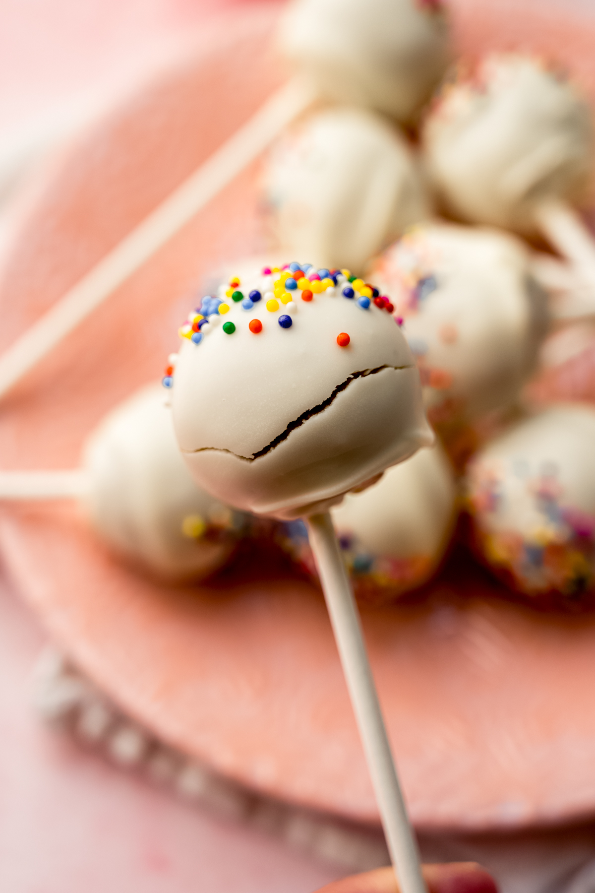A cake pop with a crack in it to show an example for troubleshooting.