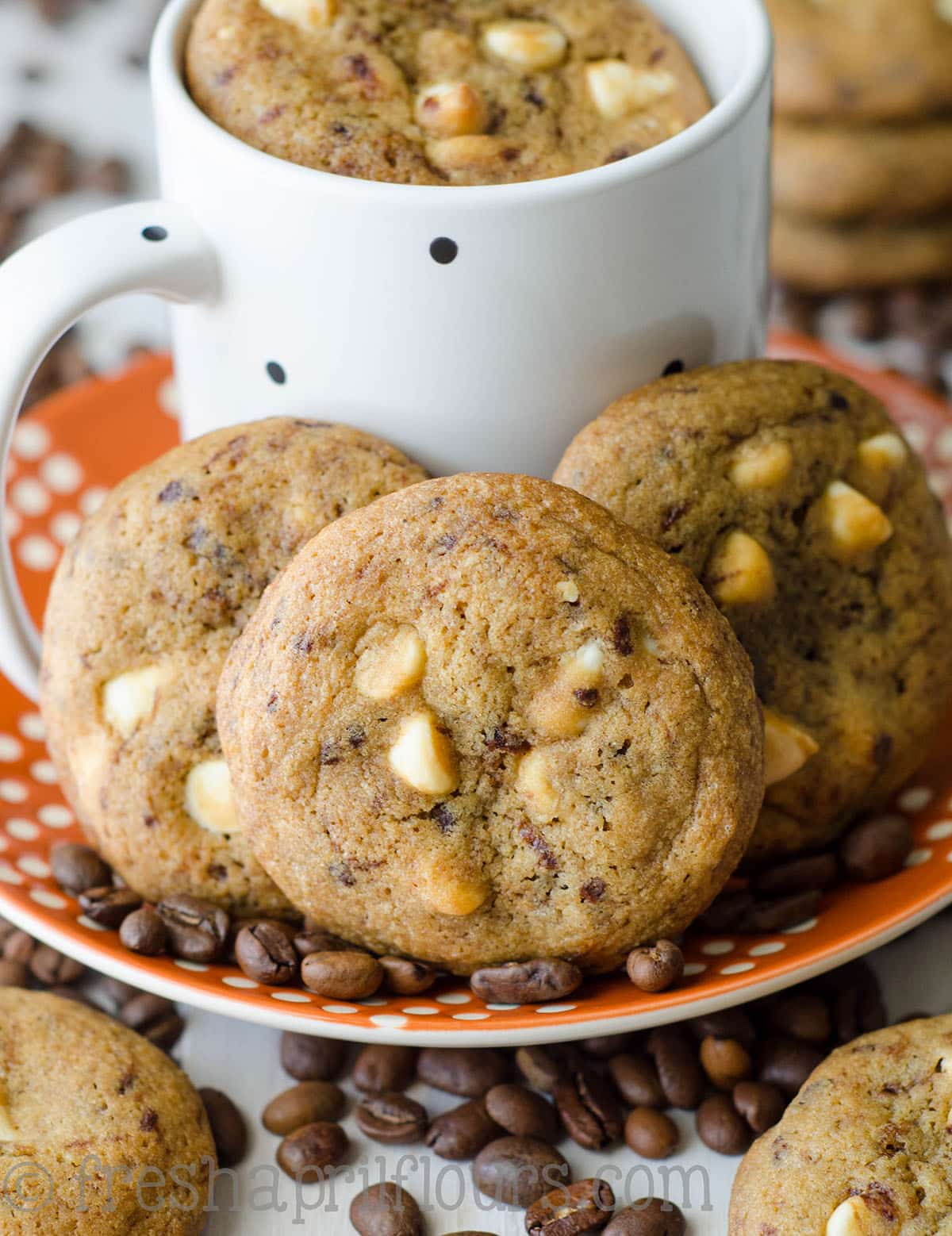 cappuccino cookies on a plate with coffee beans and a mug of coffee