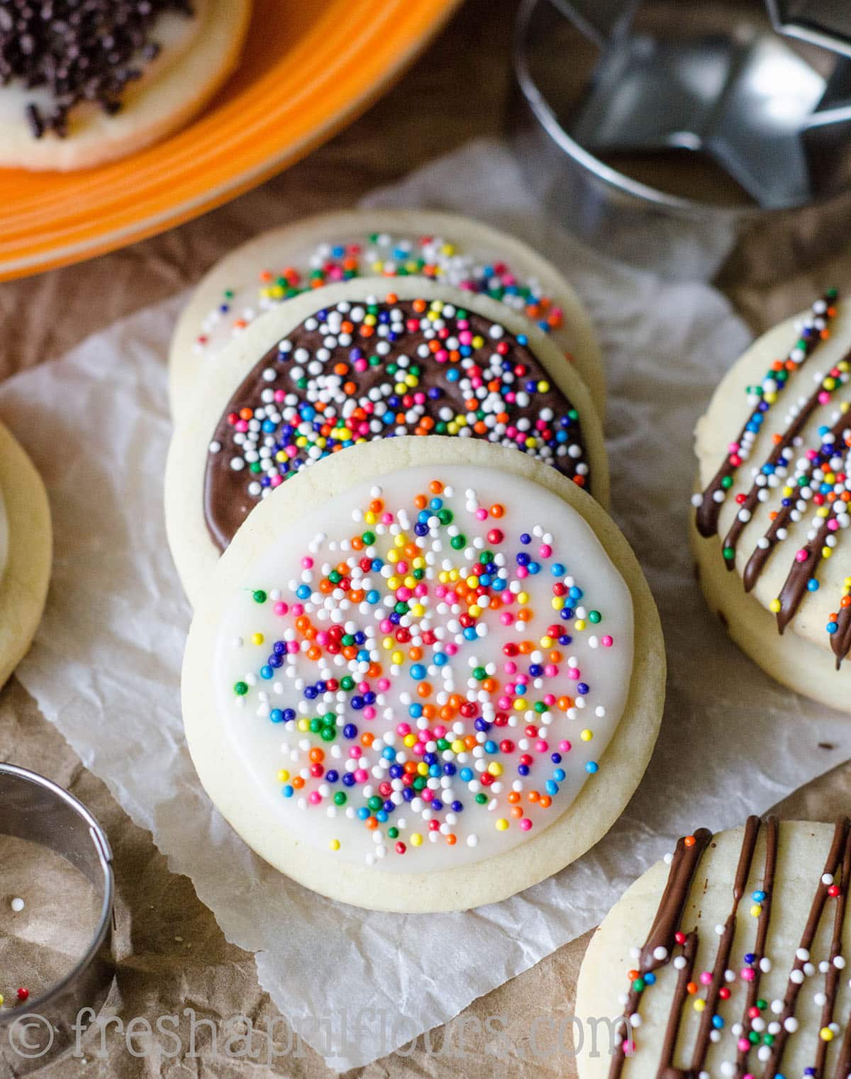 cut-out sugar cookies with icing and nonpareil sprinkles