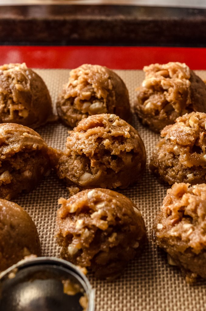 Flourless peanut butter cookie dough balls on a baking sheet ready to bake.