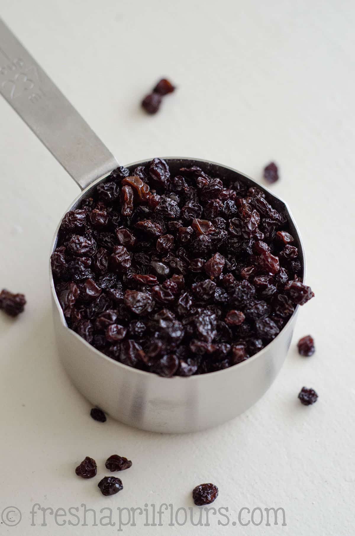 Currants in a measuring cup for Irish soda bread.