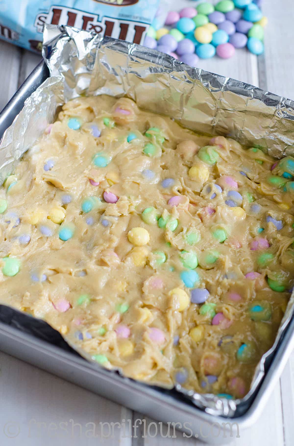 Peeps blondies batter pressed into a baking dish.