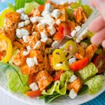 Buffalo Blue Salad: This protein-packed salad features spicy buffalo chicken, crisp banana peppers, juicy grape tomatoes, and tangy blue cheese crumbles.