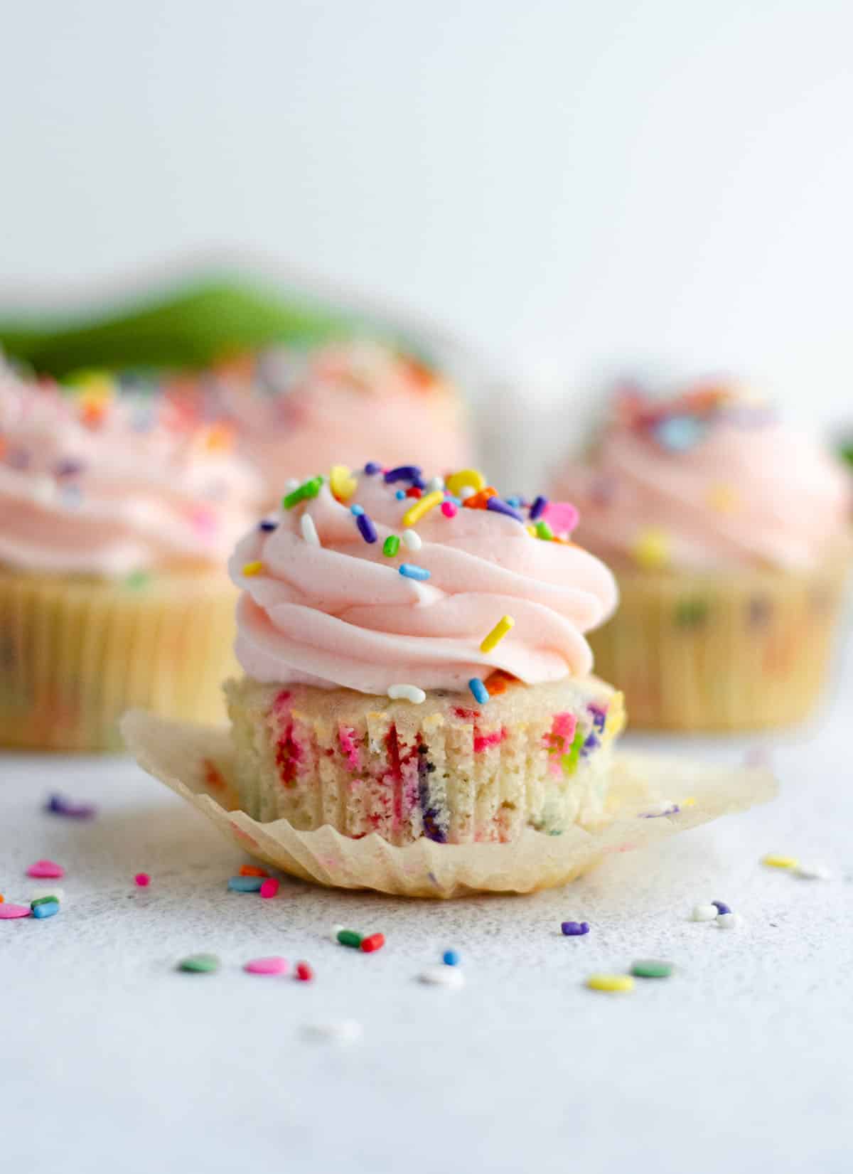 pink cupcakes with rainbow sprinkles