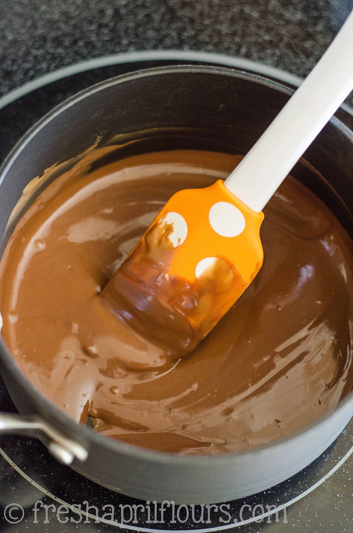 Biscoff puppy chow mixture in a saucepan.