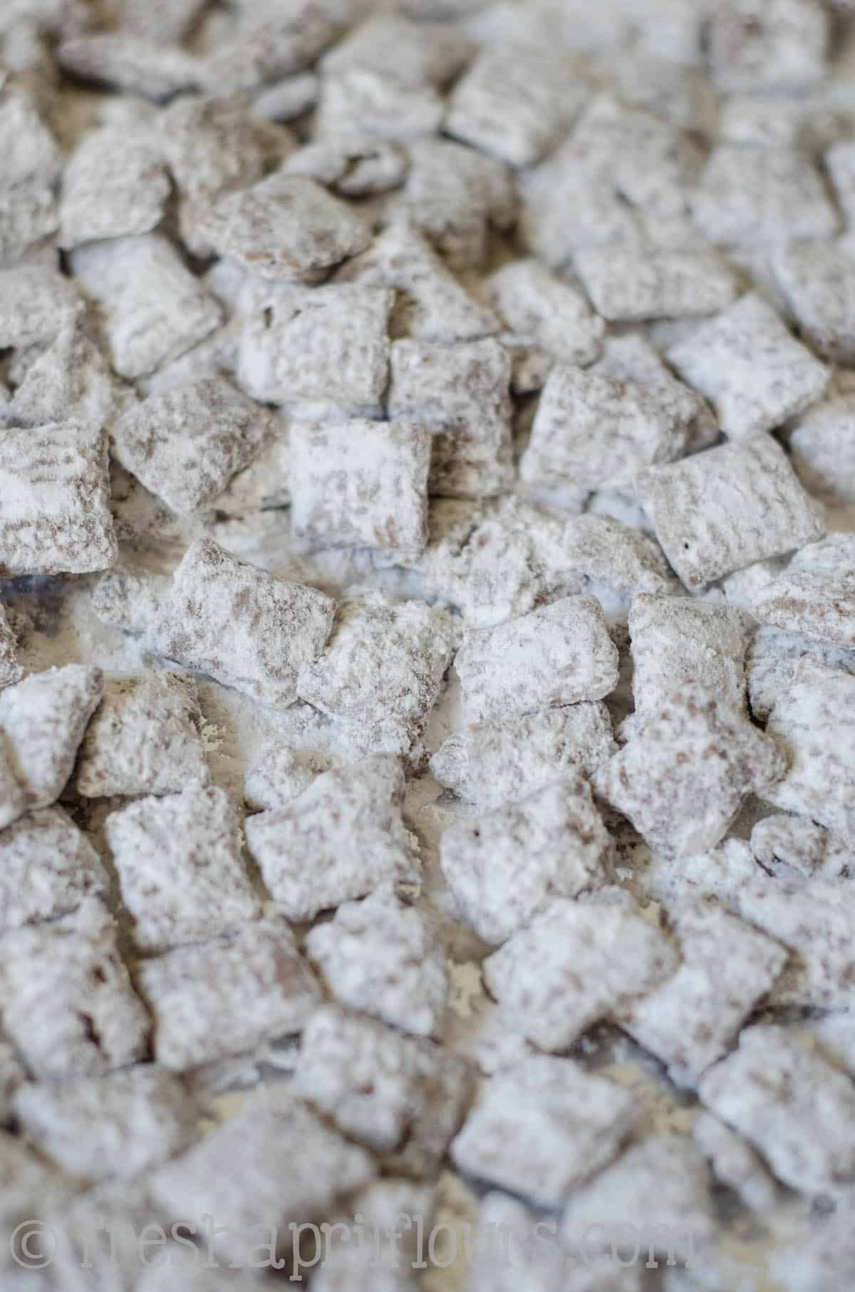 Biscoff puppy chow spread onto a surface.