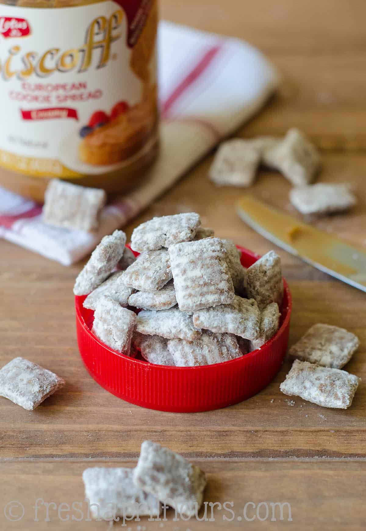 Biscoff puppy chow in the lid of a Biscoff jar.