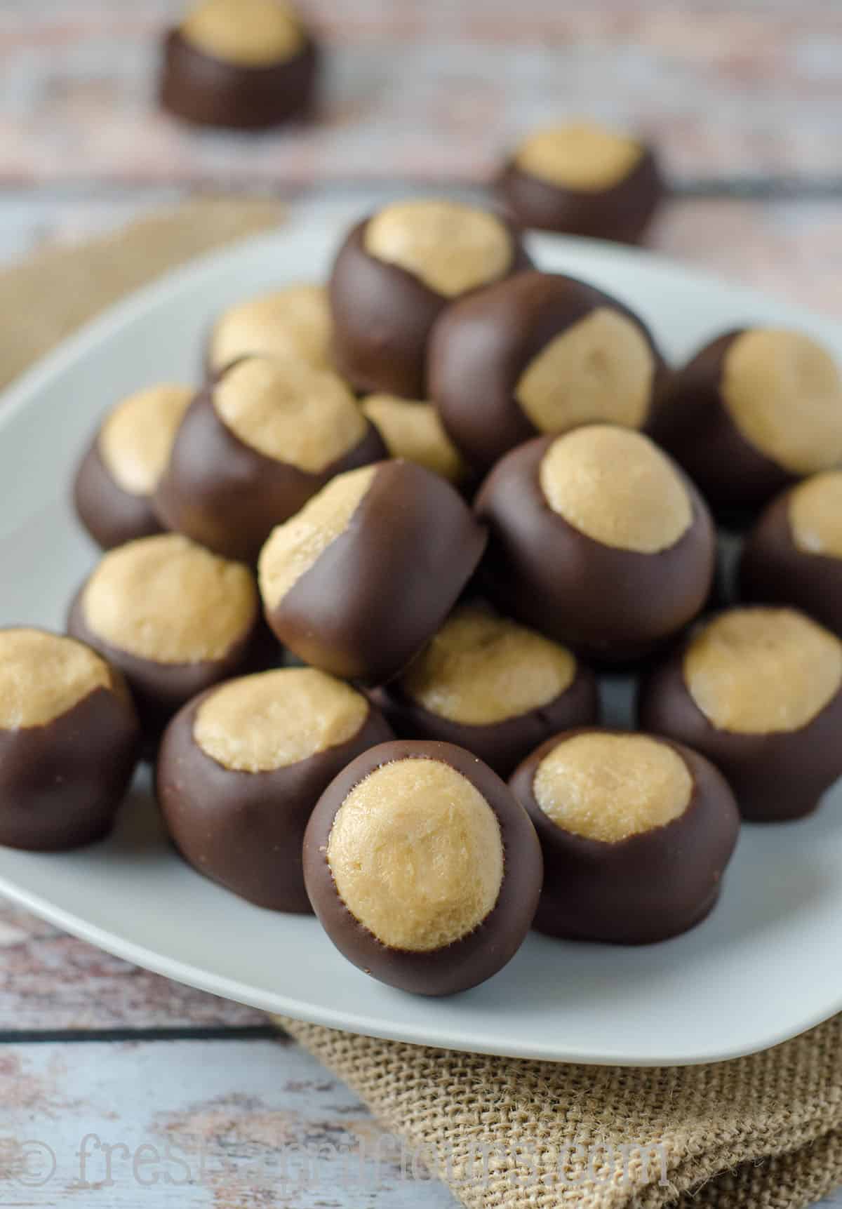 Buckeye Candy: Easy, melt-in-your-mouth peanut butter buckeye balls dipped in chocolate. A classic!