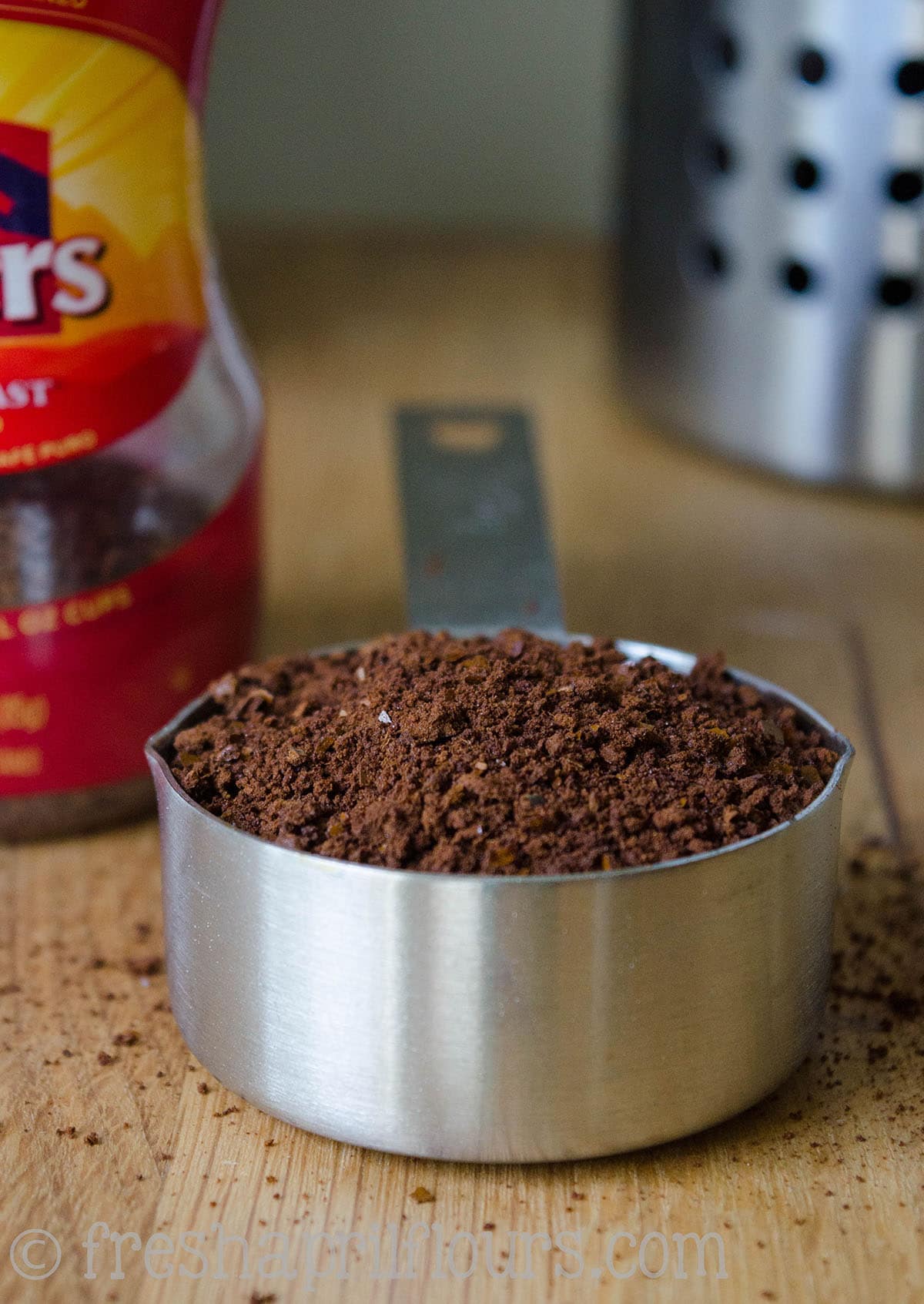 Coffee grounds in a measuring cup.