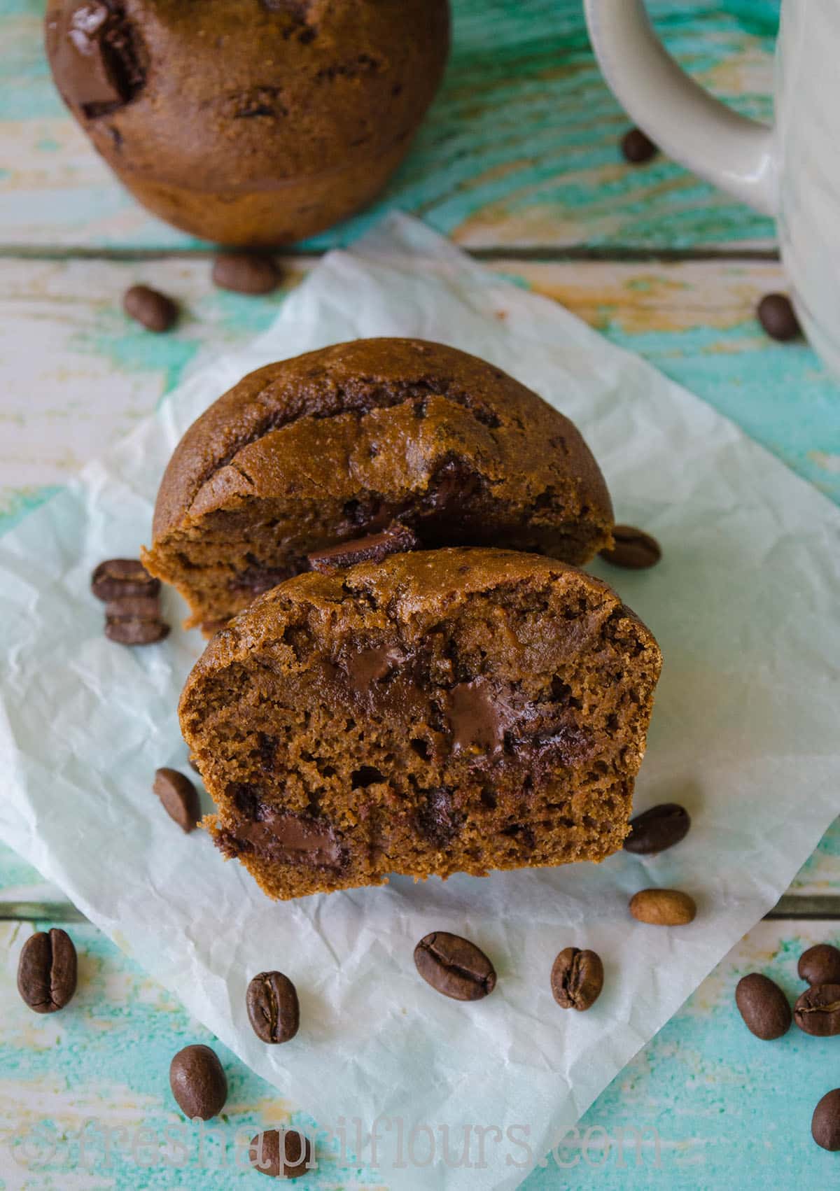 Mocha chocolate chunk muffin sliced open to see the inside.