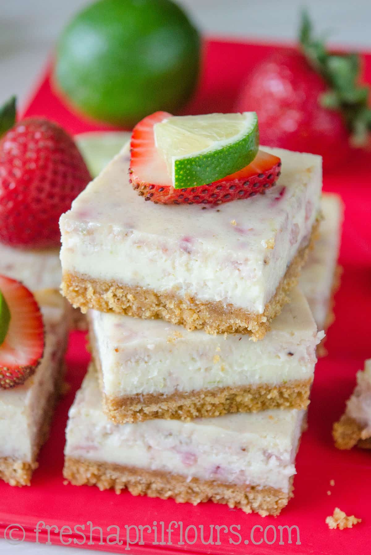 Strawberry Margarita Squares: A tart and creamy lime cheesecake filling is bursting with juicy strawberries and jazzed up with tequila. Perfect for a summer picnic!