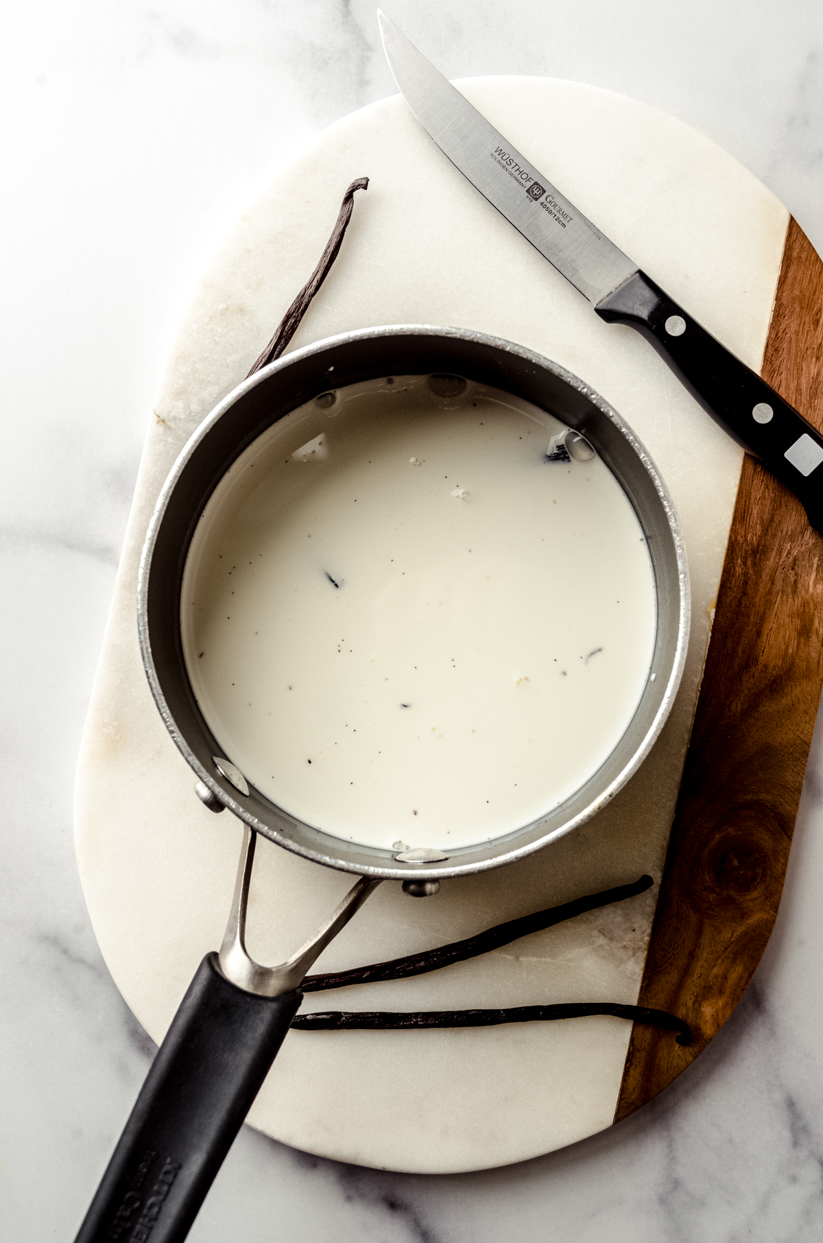 Aerial photo of a saucepan of vanilla infused half and half to make homemade creamer.