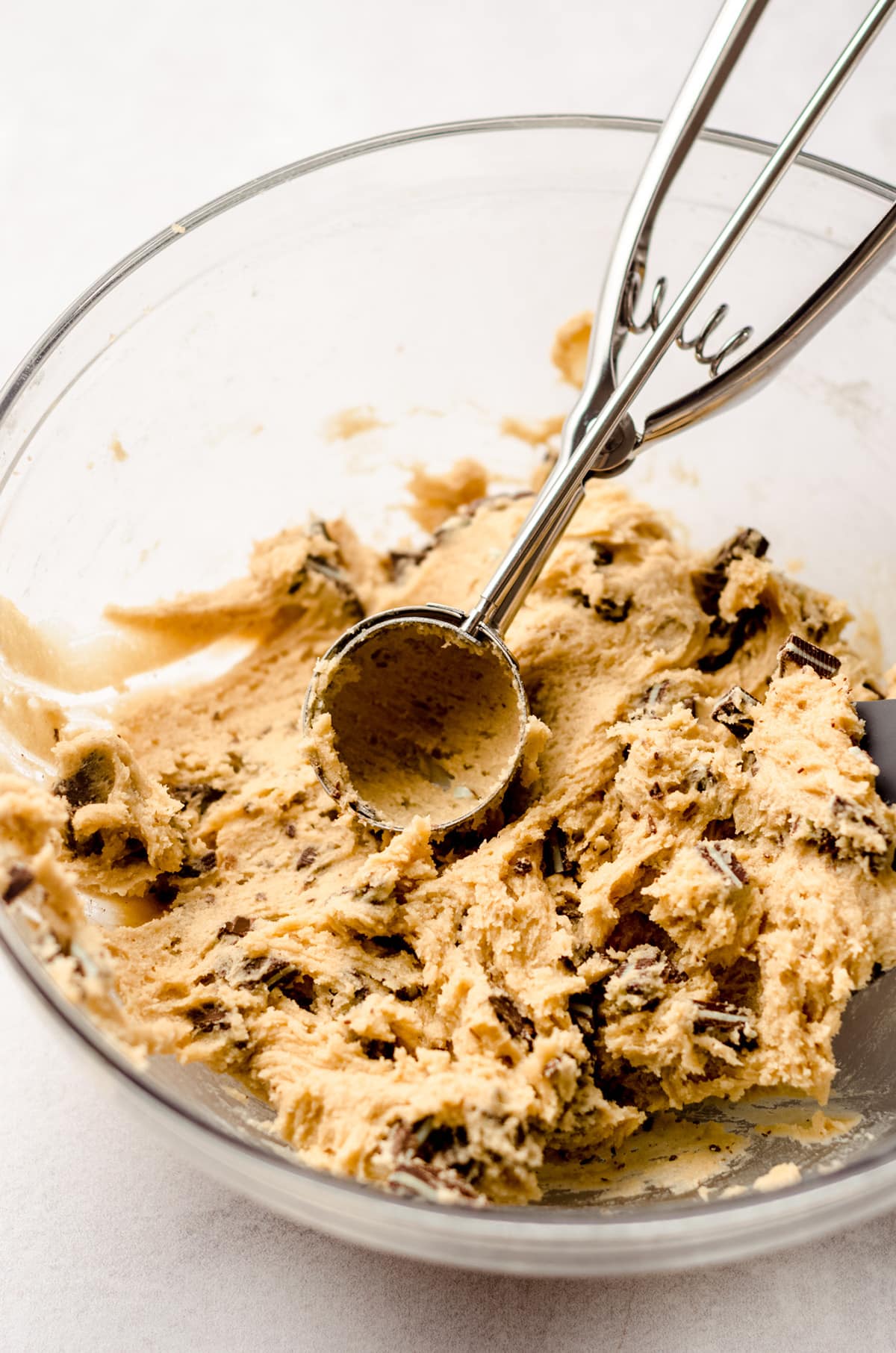 andes mint cookie dough in a bowl with a cookie scoop