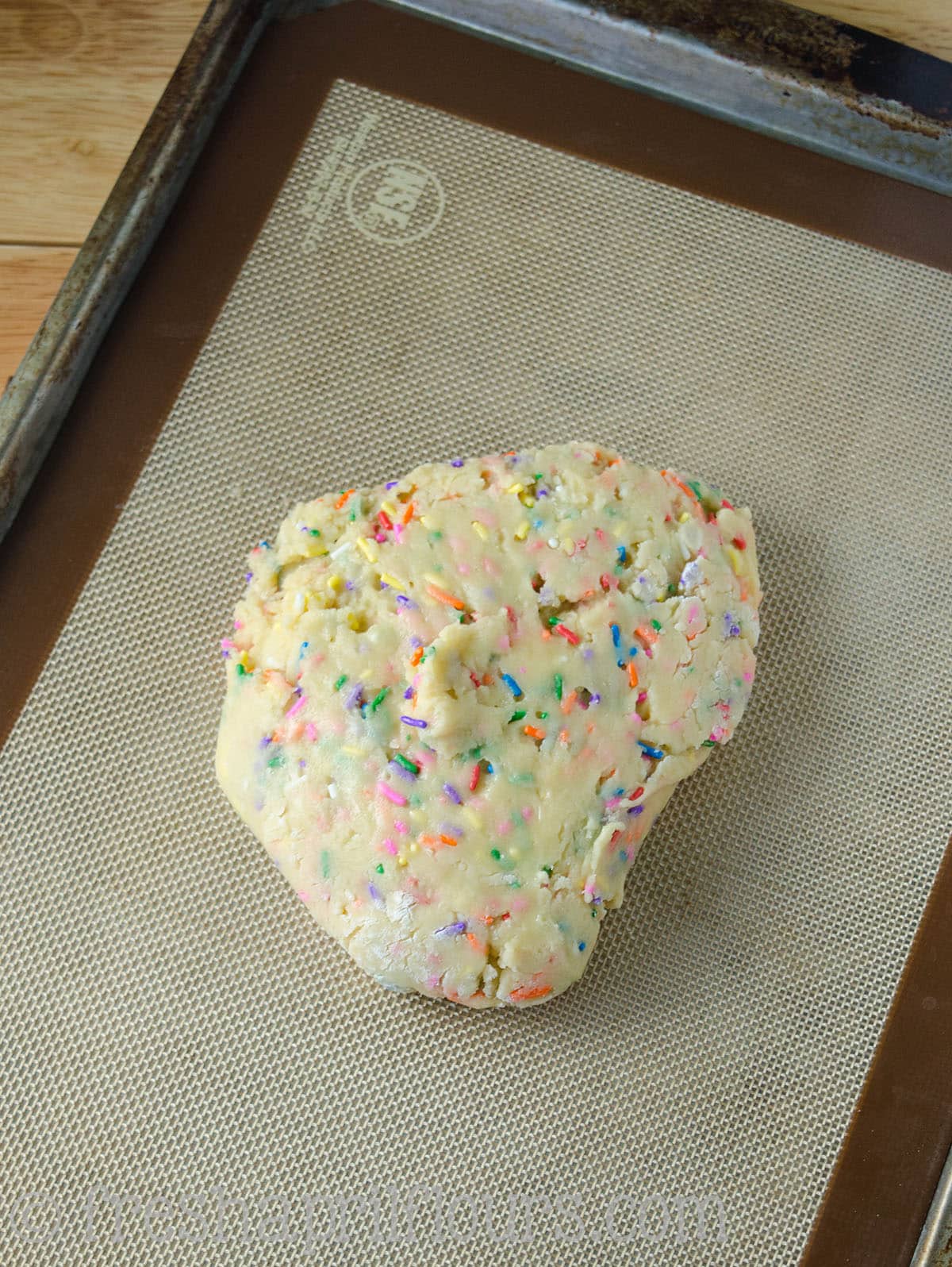 Funfetti biscotti dough in a ball.