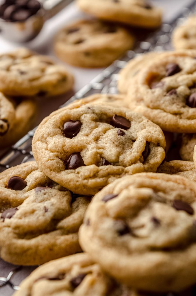 Mini chocolate chip cookies on a cooling rack.