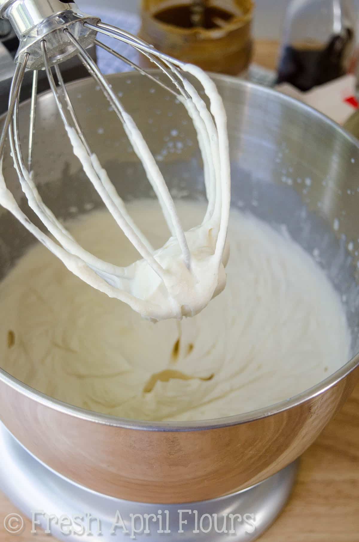 No churn ice cream base in a stand mixer with the whisk attachment.