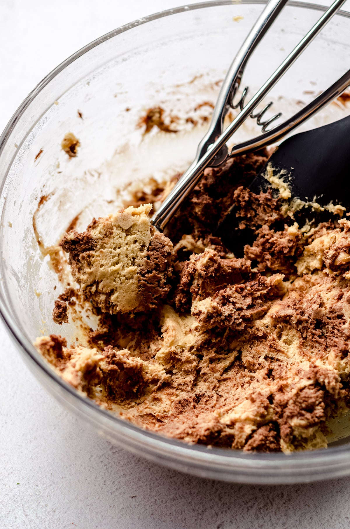 nutella peanut butter chip cookie dough in a bowl with a cookie scoop