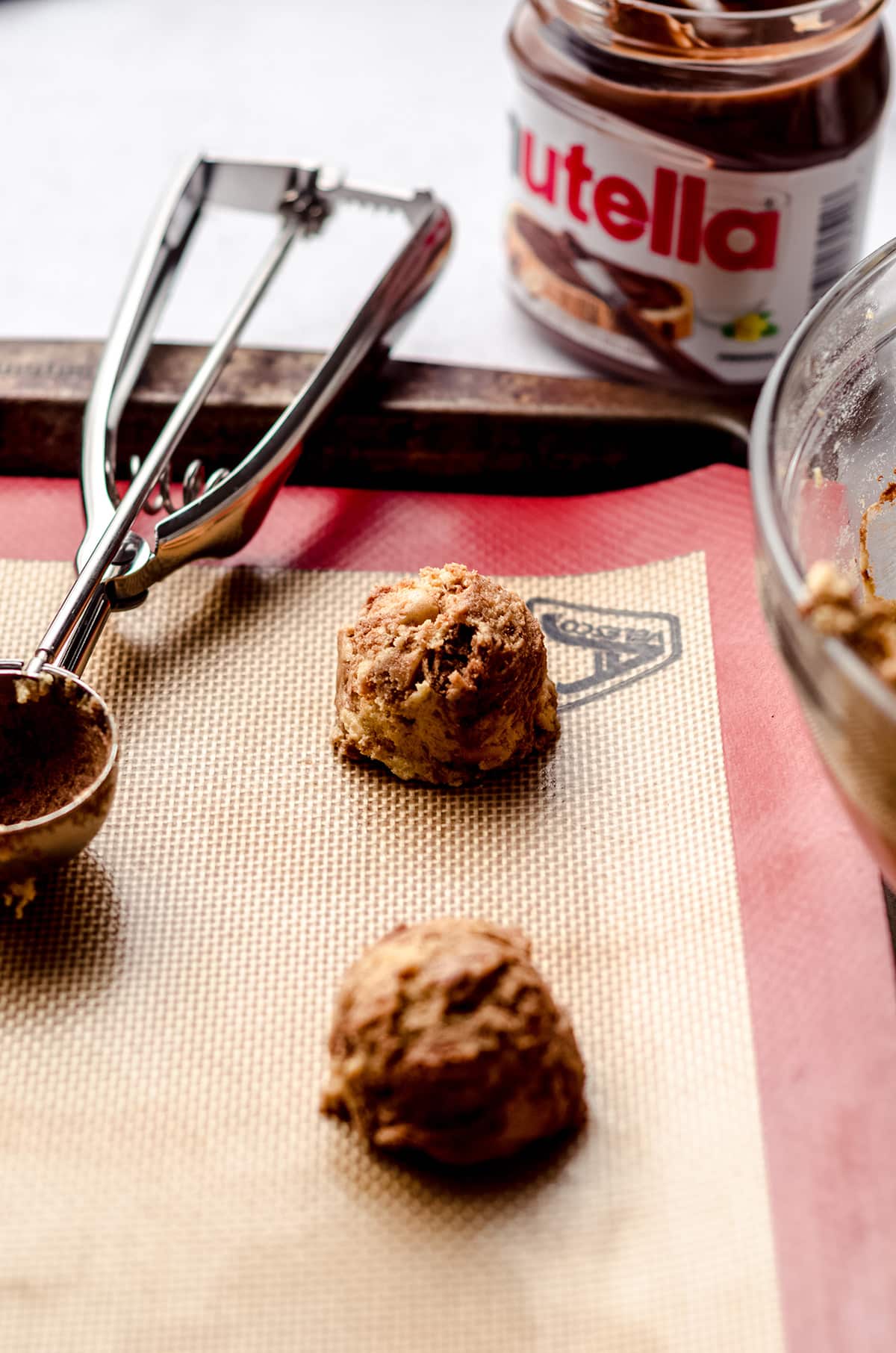 nutella peanut butter chip cookie dough balls on a baking sheet