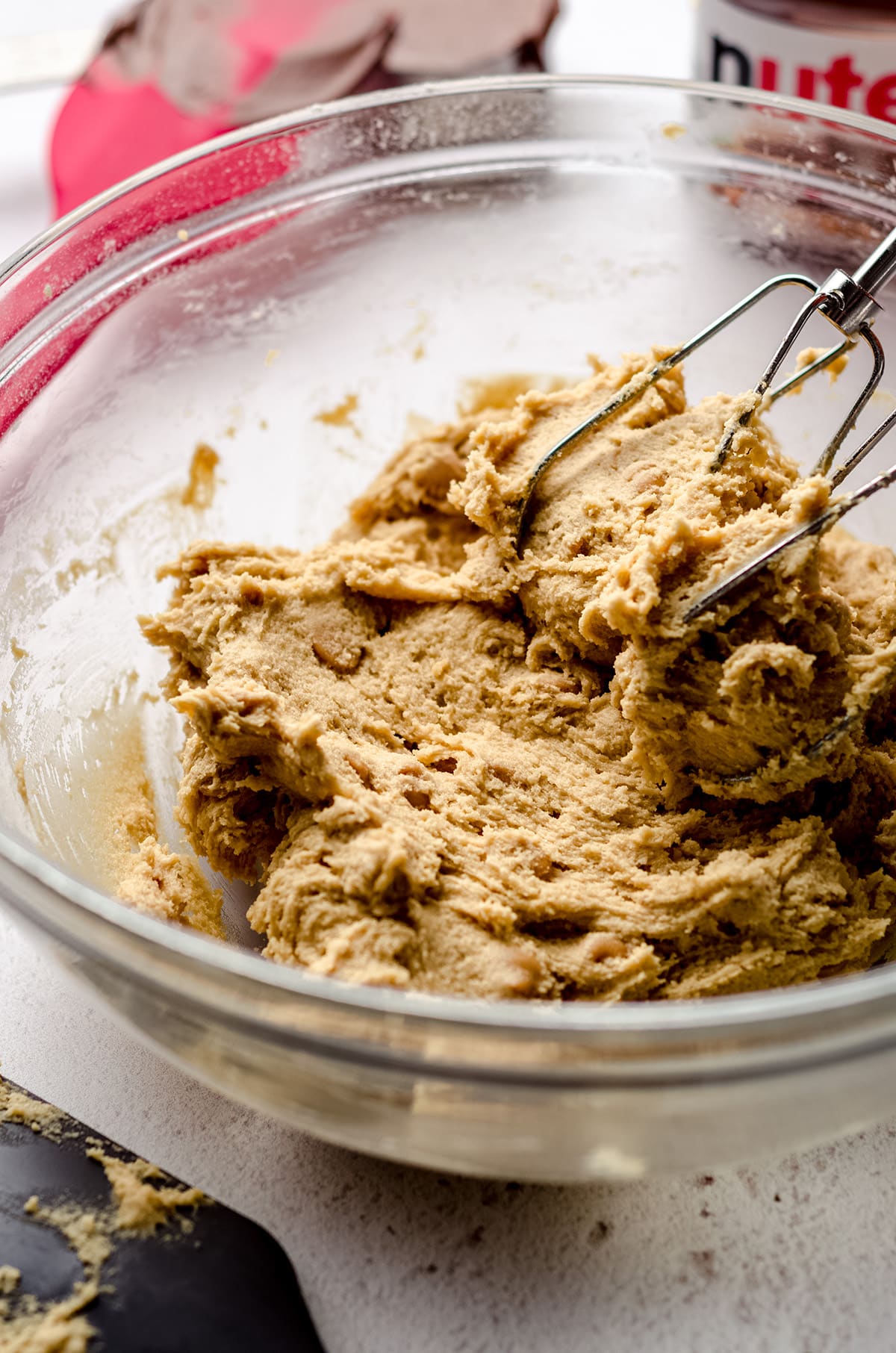 cookie dough in a bowl with beaters