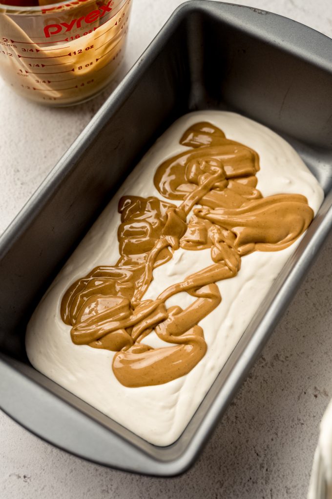 A container of peanut butter ripple ice cream in progress.