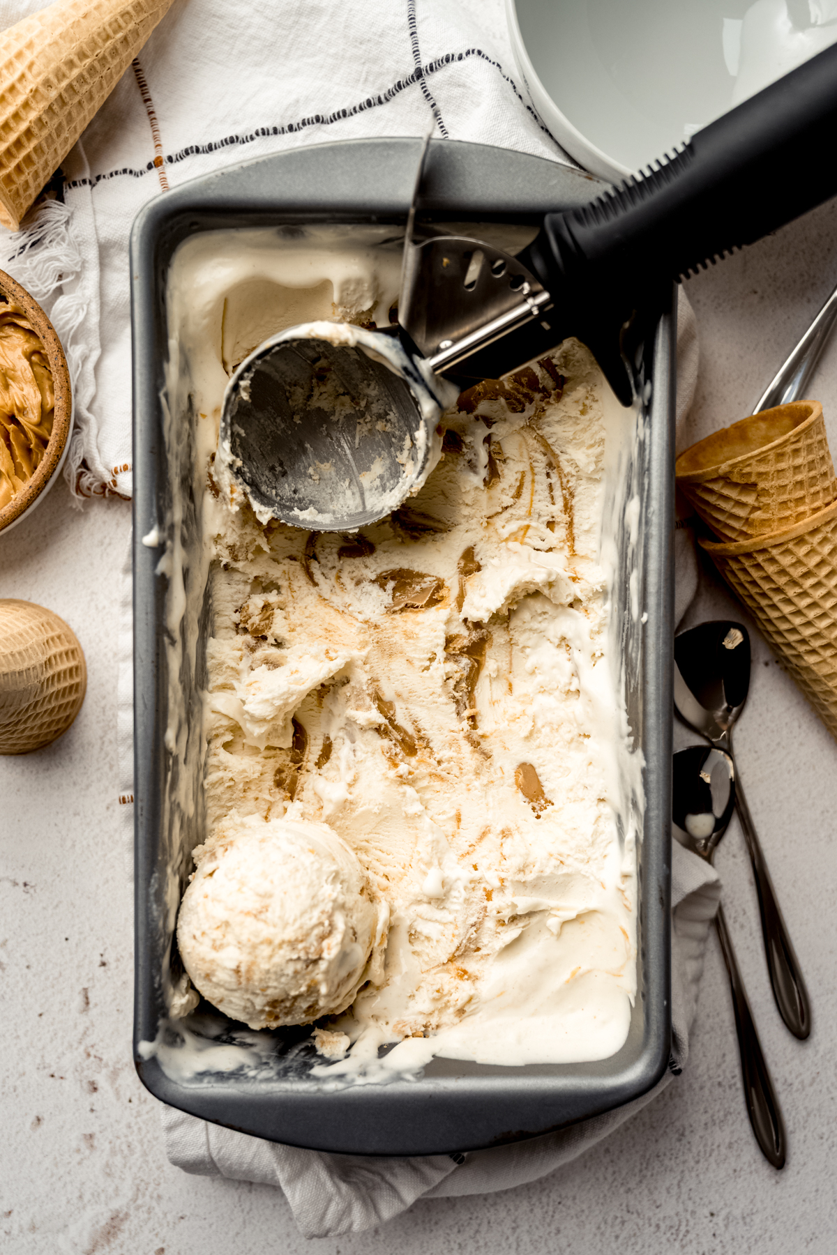 Aerial photo of a loaf pan with peanut butter ripple ice cream in it.