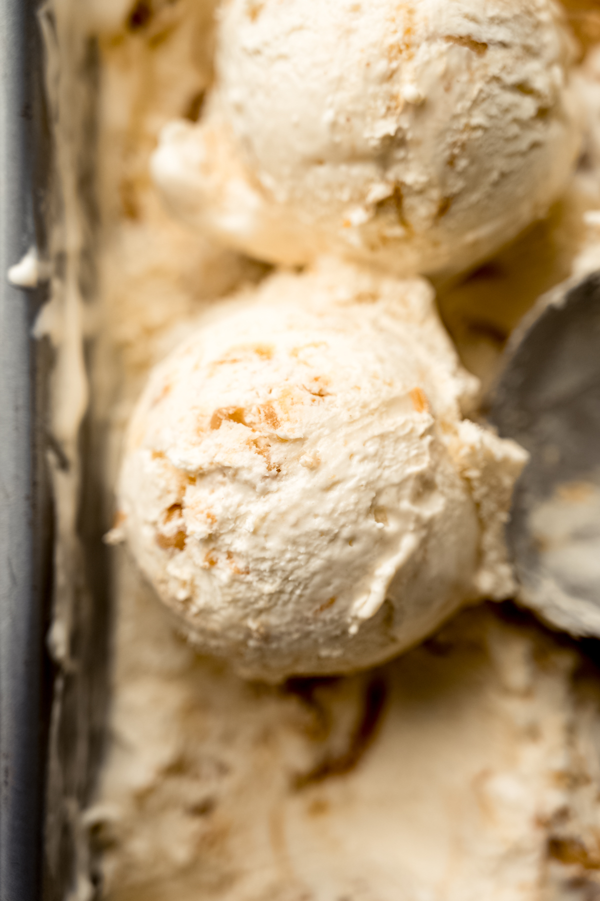 Aerial photo of peanut butter ripple ice cream that has been scooped.