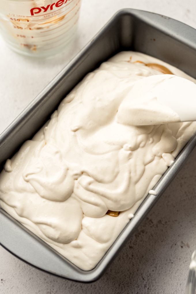 A container of peanut butter ripple ice cream in progress.