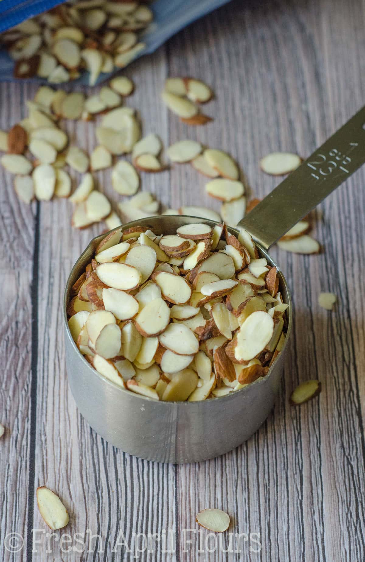 Slivered almonds in a measuring cup.