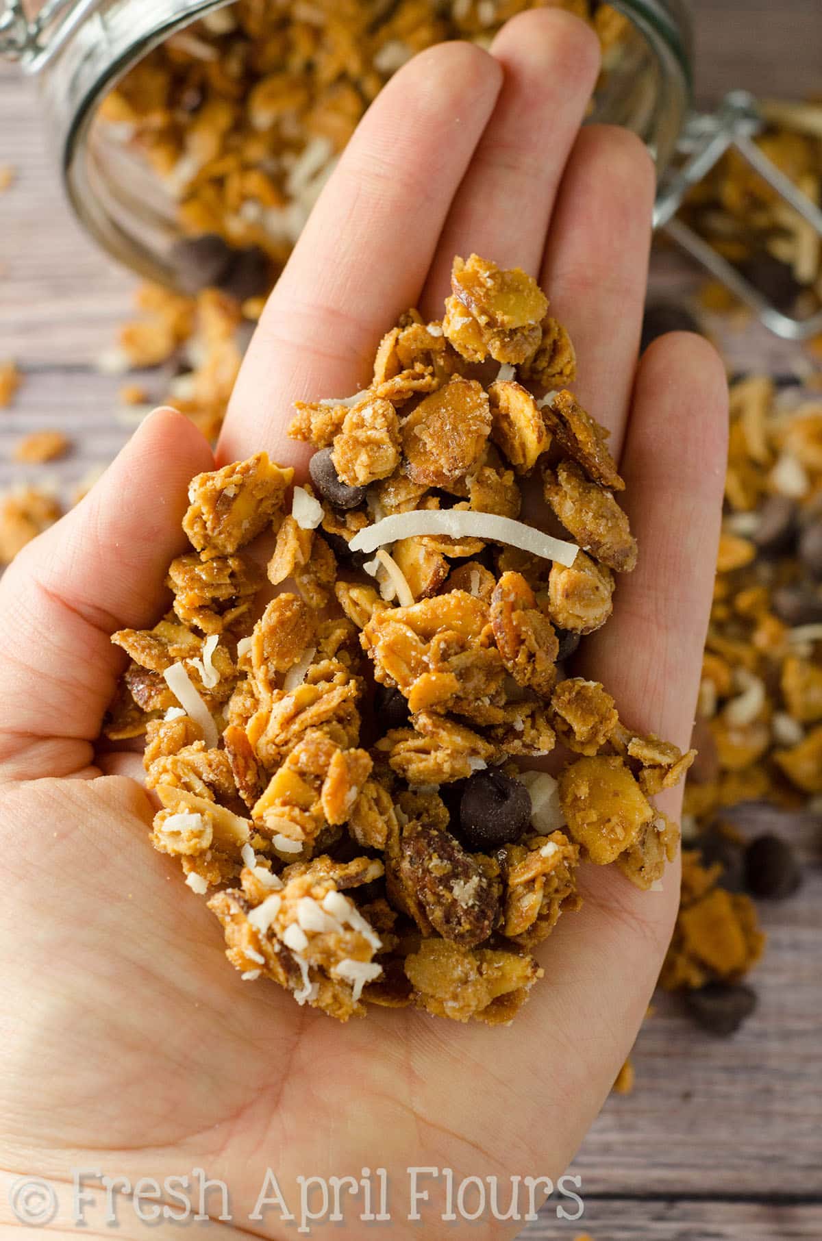 A hand holding Almond Joy granola.