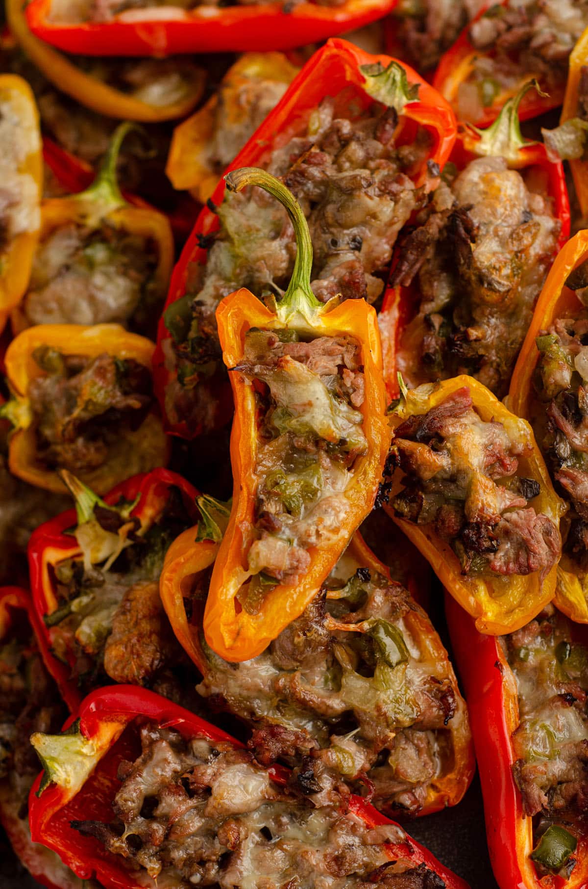 mini philly cheesesteak stuffed peppers in a pile on a plate