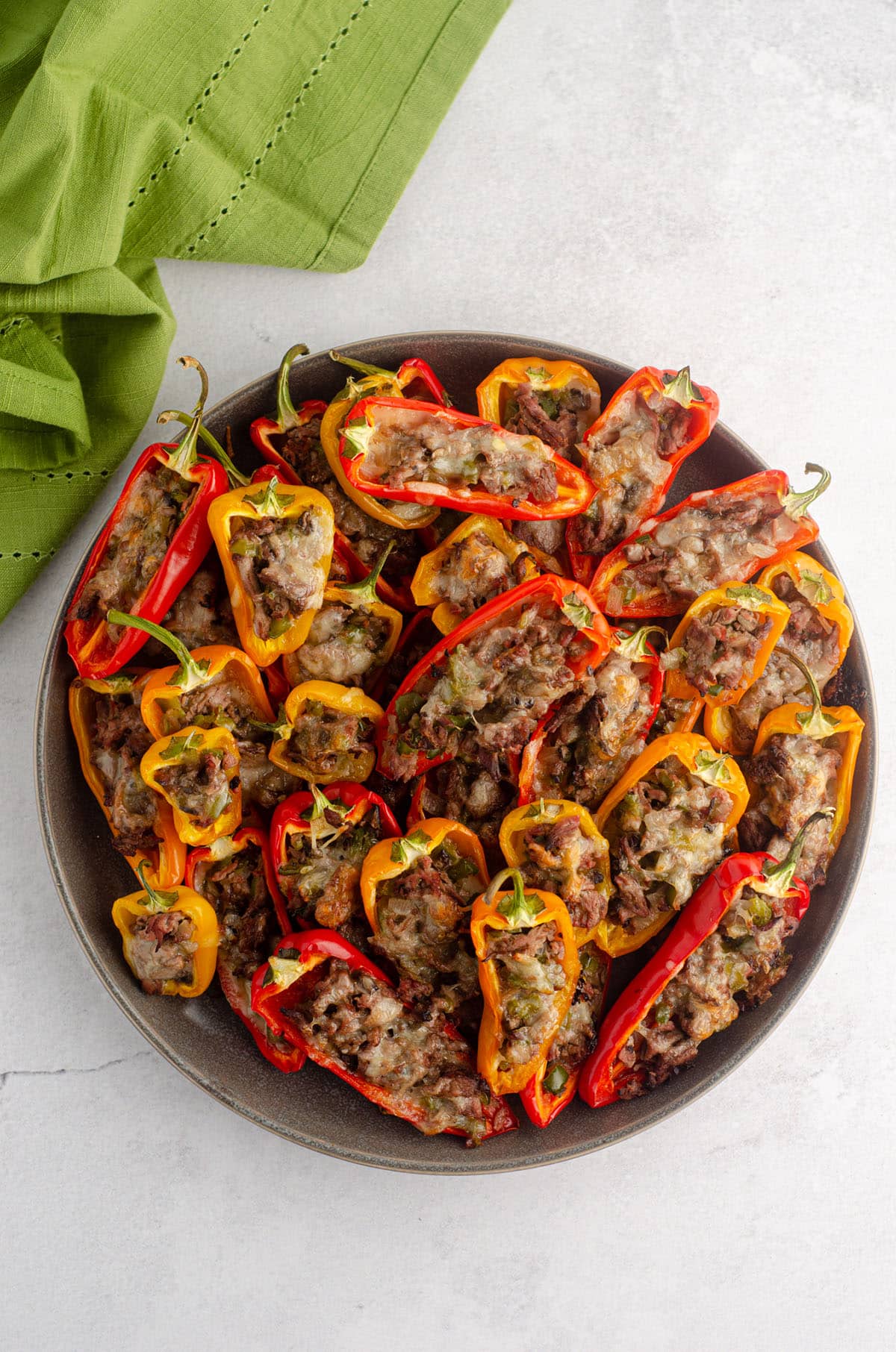 aerial photo of a plate of mini philly cheesesteak stuffed peppers