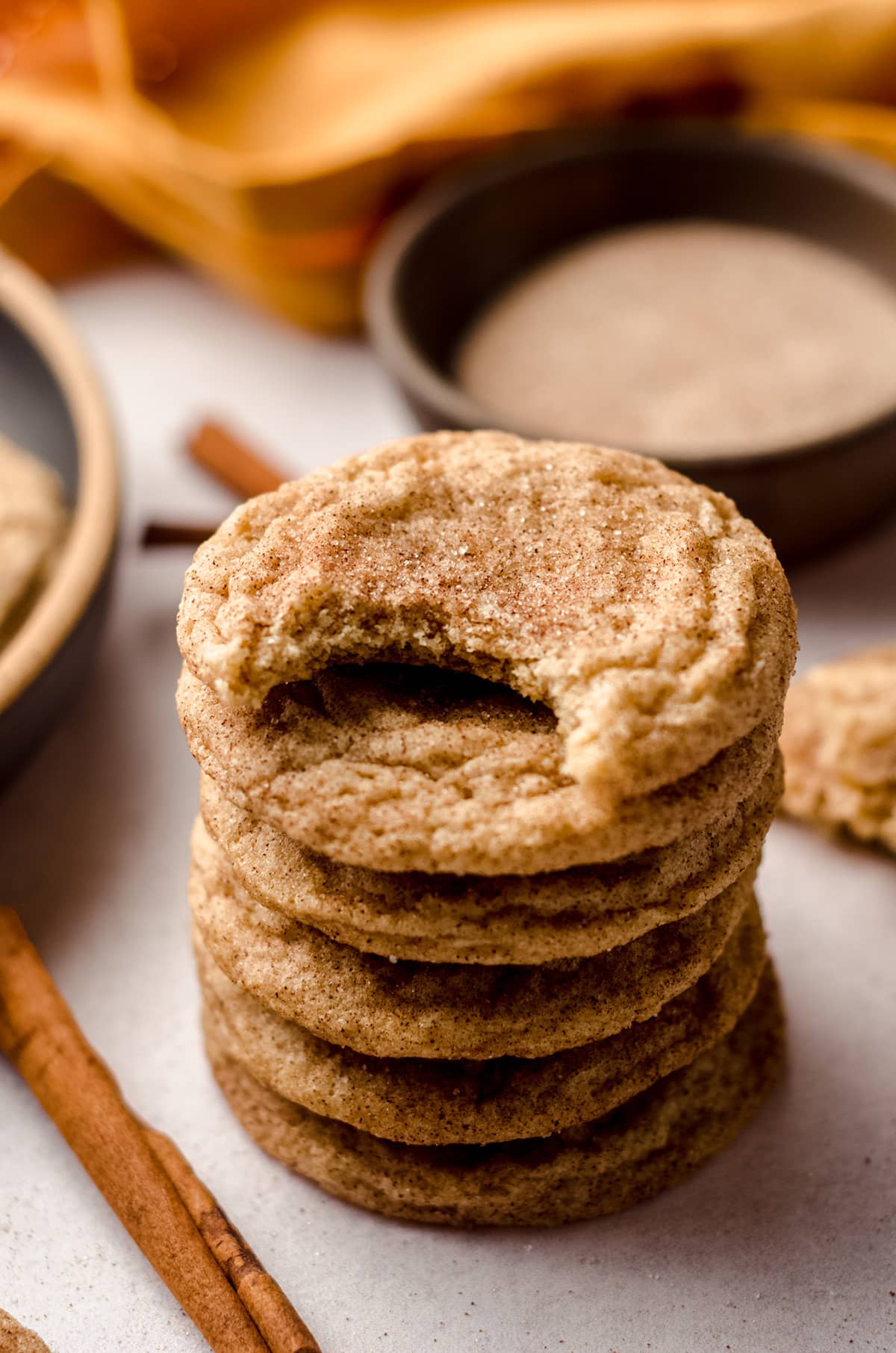 stack of snickerdoodle cookies with a bite taken out of one of them