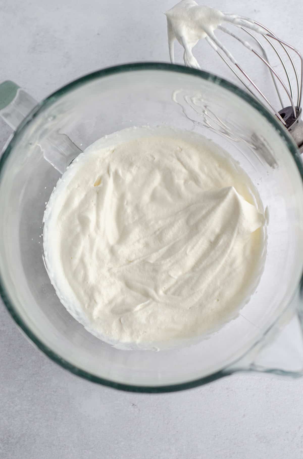 aerial photo of stiff peaks in homemade whipped cream in a glass bowl 