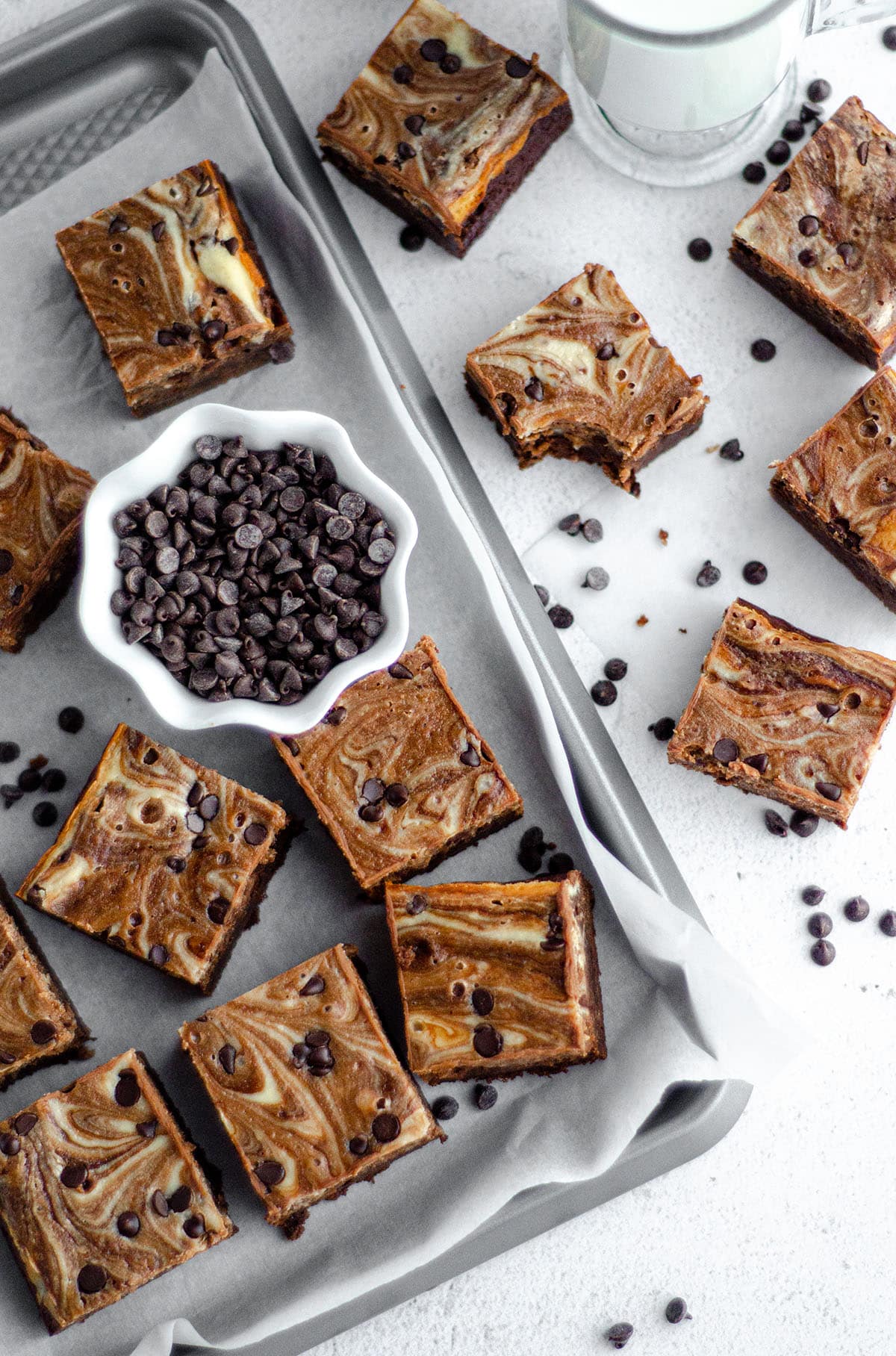 aerial photo of cut brownies in a group with a small bowl of mini chocolate chips