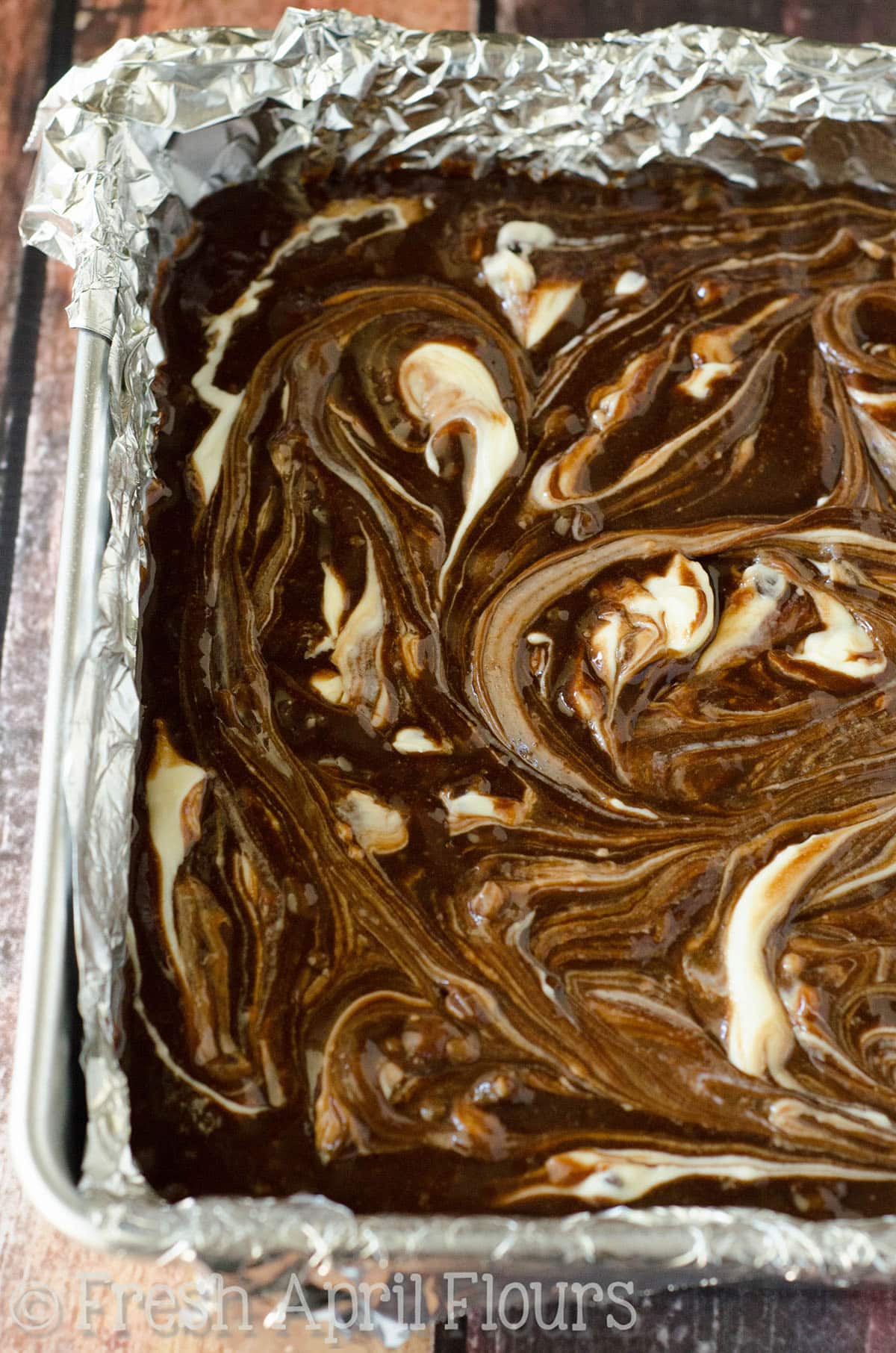 Chocolate Chip Cheesecake Swirl Brownies: Dense and fudgy scratch brownies swirled with sweet chocolate chip cheesecake. 
