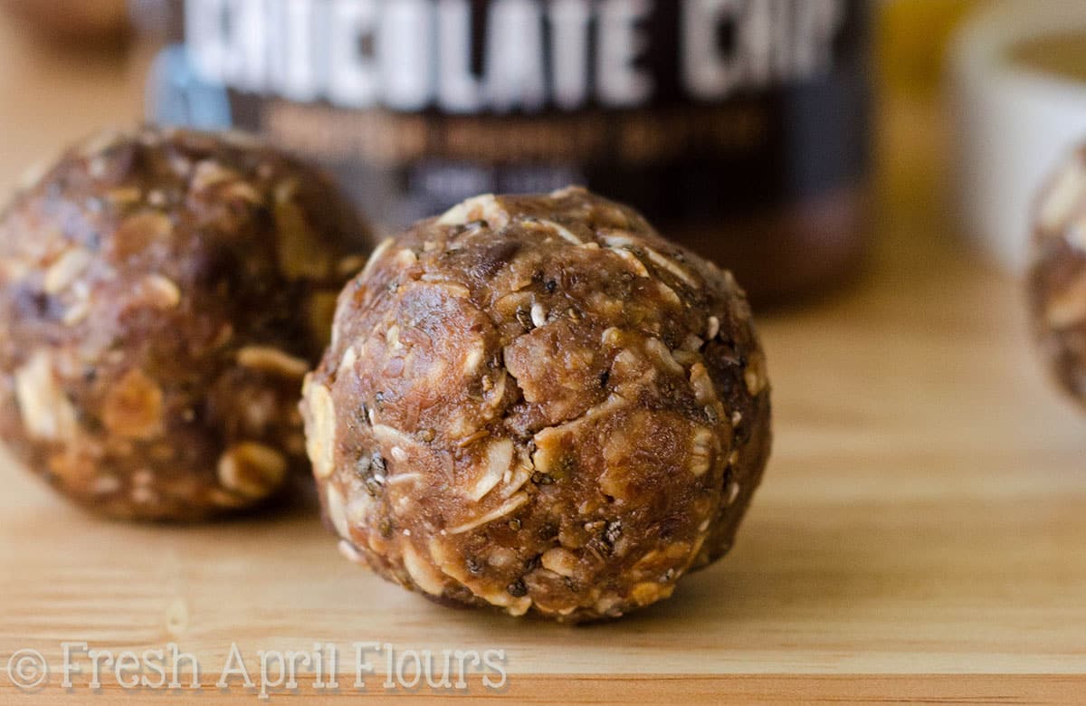 A chocolate chip oat bite on a wooden surface.