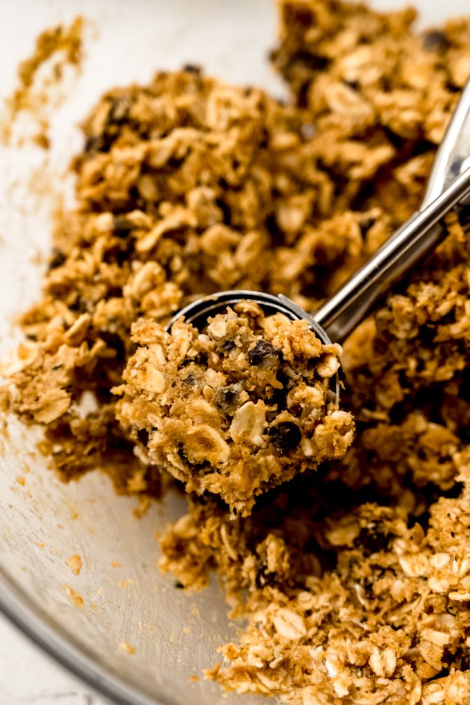 The mixture for chocolate chip oat bites in a cookie scoop.