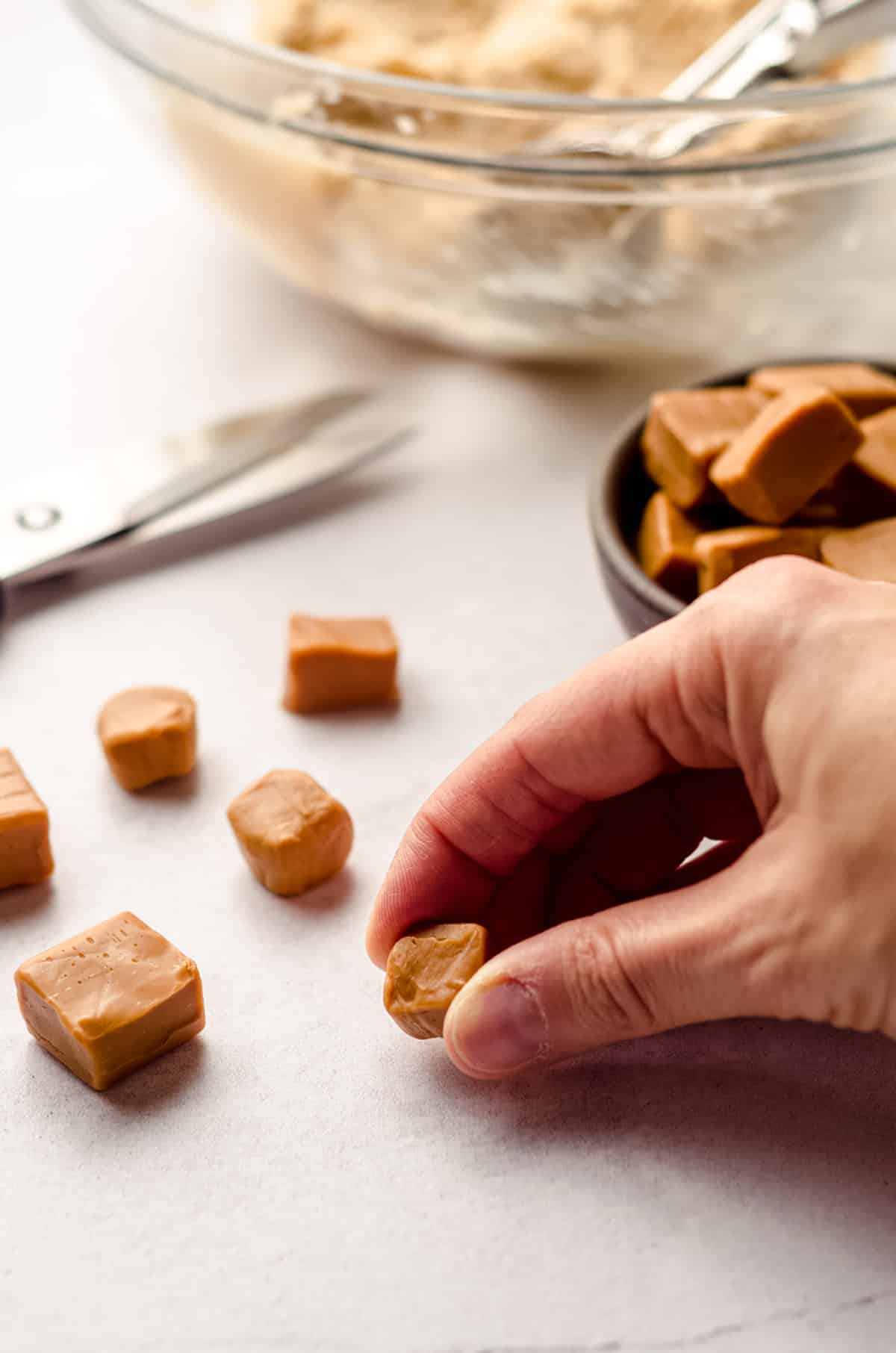 shaping a caramel to put it into cookie dough