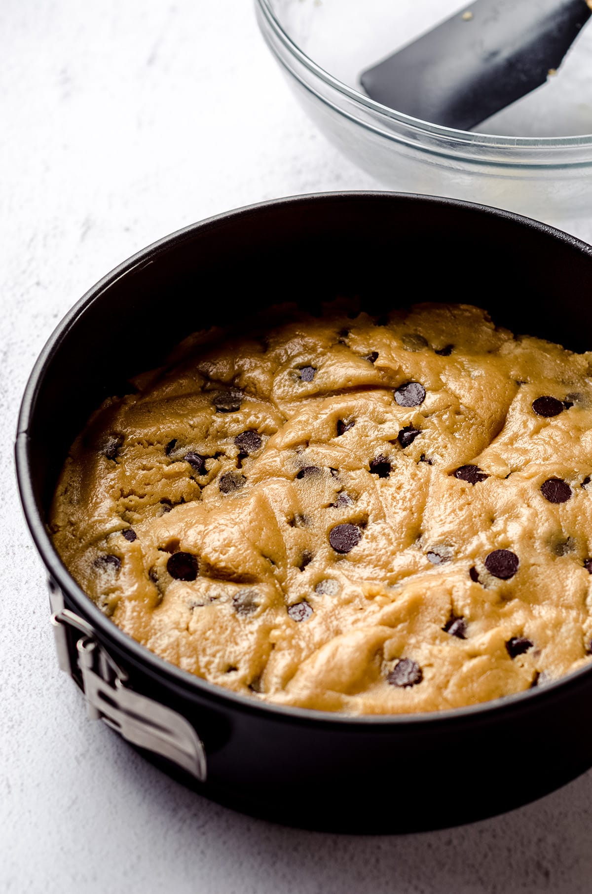 chocolate chip cookie cake dough in a springform pan