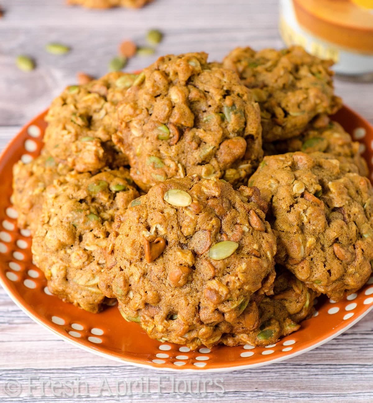 Pumpkin oatmeal cookies on an orange plate.