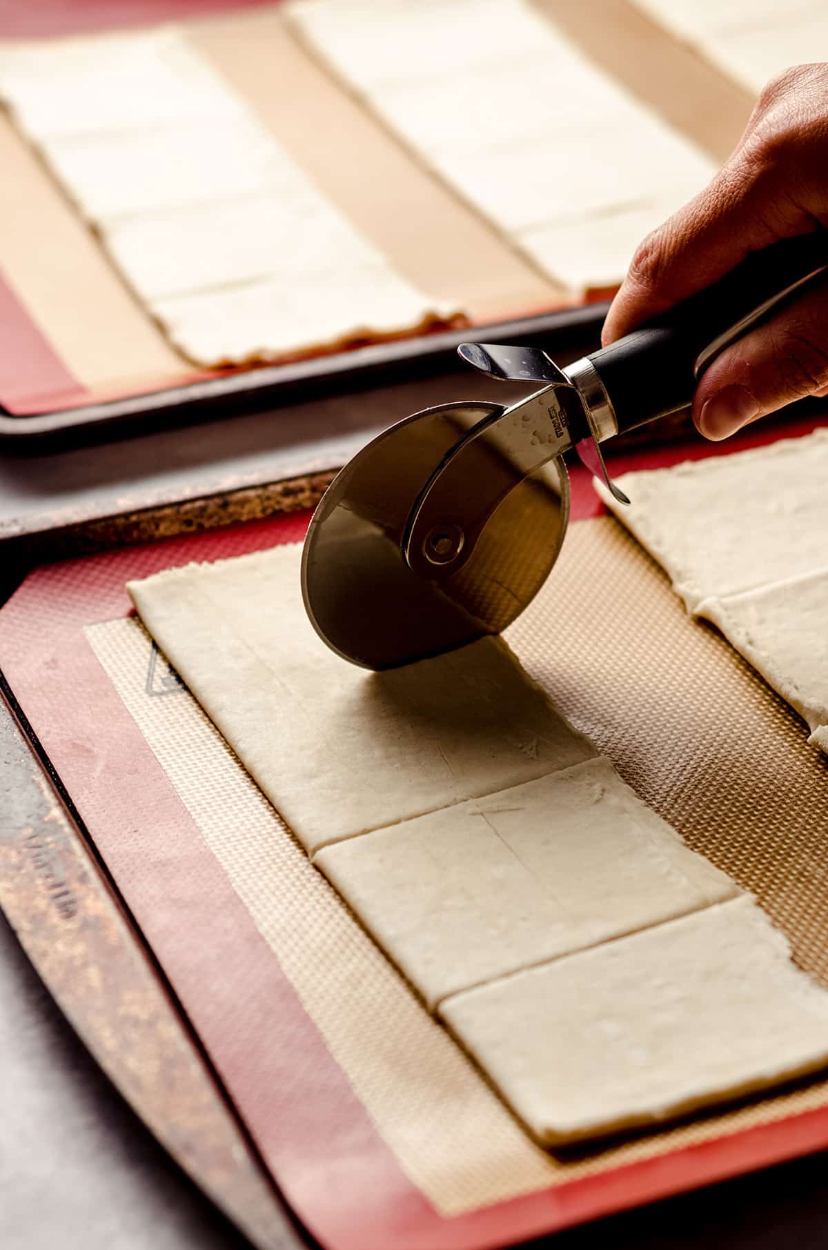 slicing puff pastry with a pizza cutter