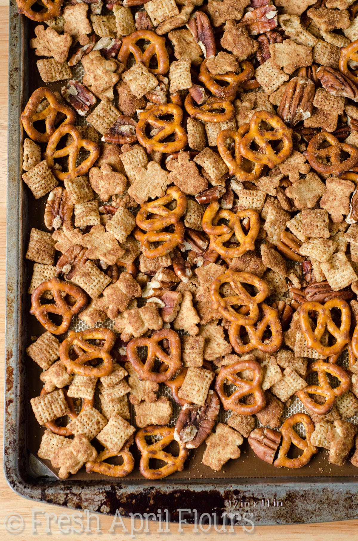 Aerial photo of pumpkin spice chex mix on a baking sheet.