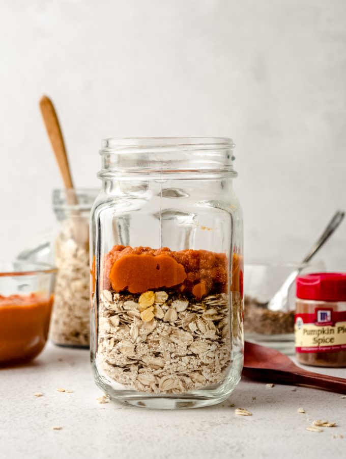 A Mason jar of ingredients to make pumpkin overnight oats.