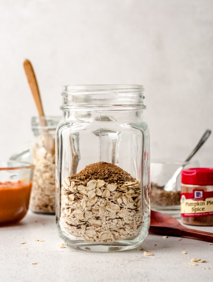 A Mason jar of ingredients to make pumpkin overnight oats.