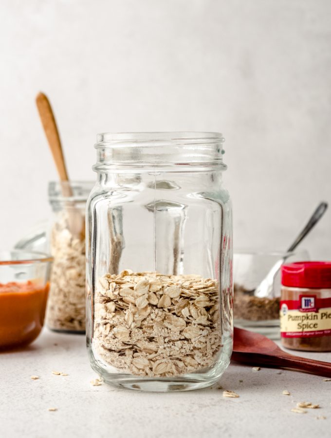 A Mason jar of ingredients to make pumpkin overnight oats.