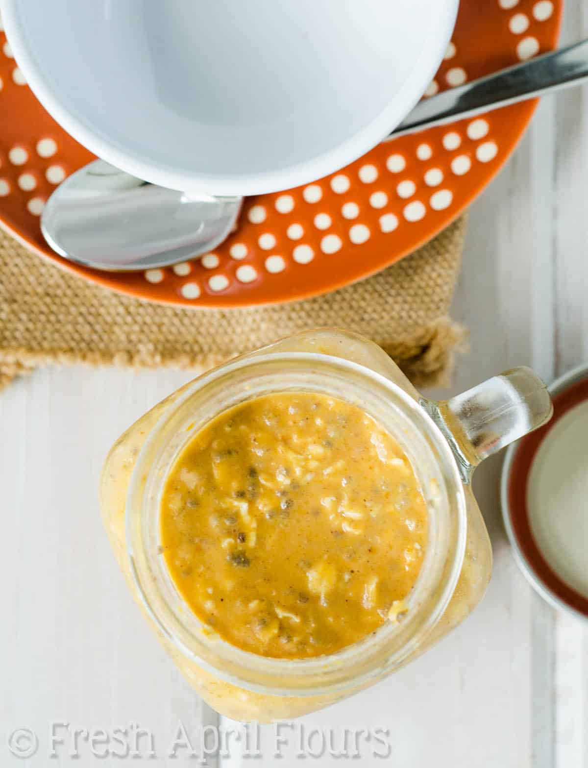 Aerial photo of pumpkin overnight oats in a mason jar.