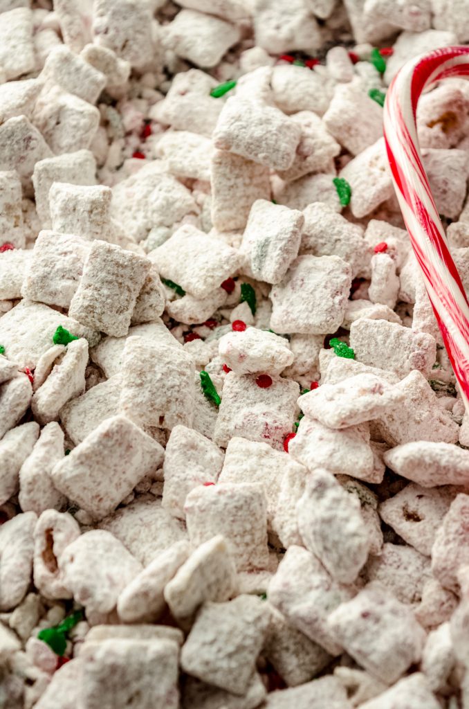 Peppermint candy cane puppy chow on a surface.