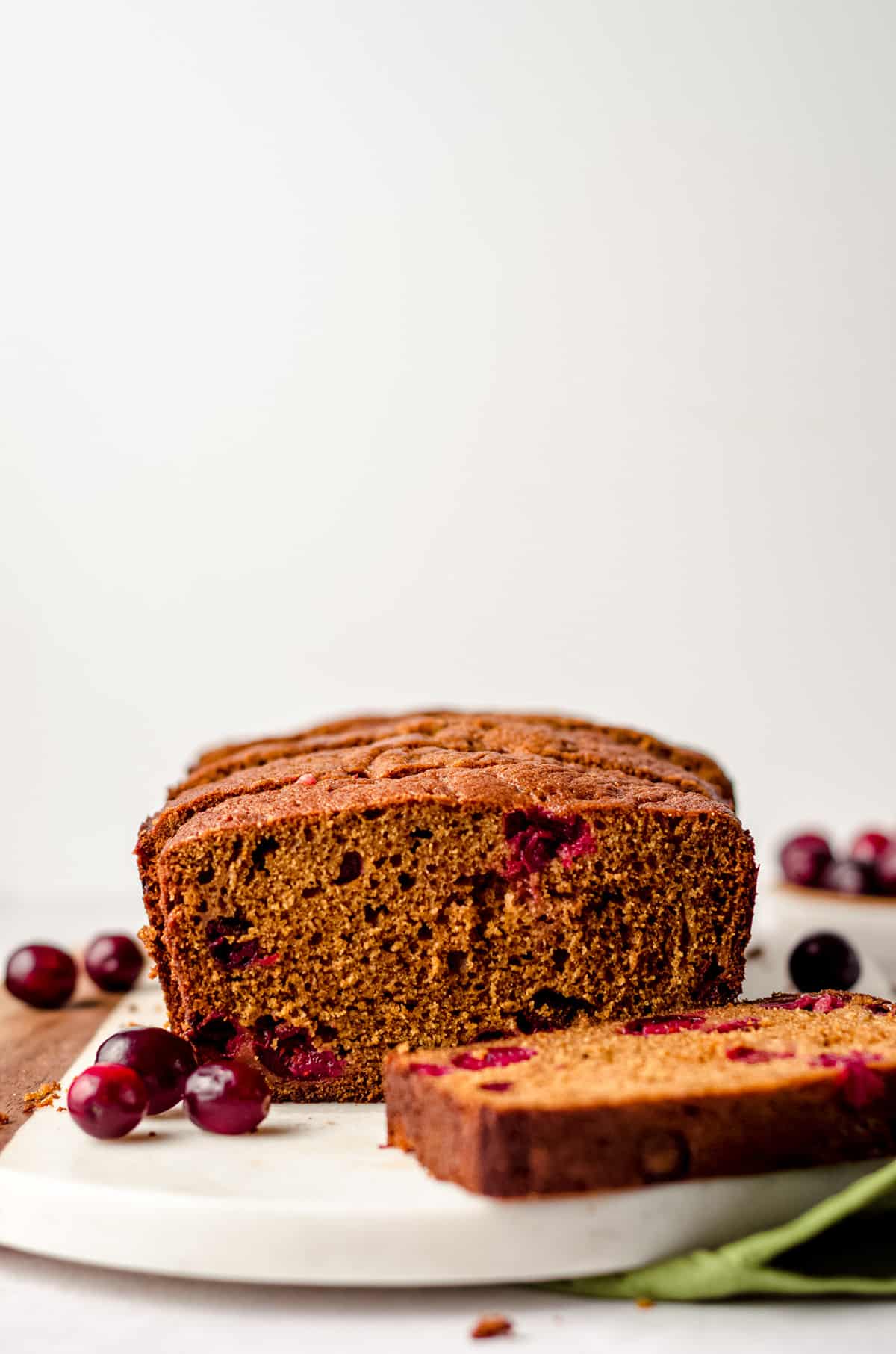 sliced cranberry gingerbread on a cutting board