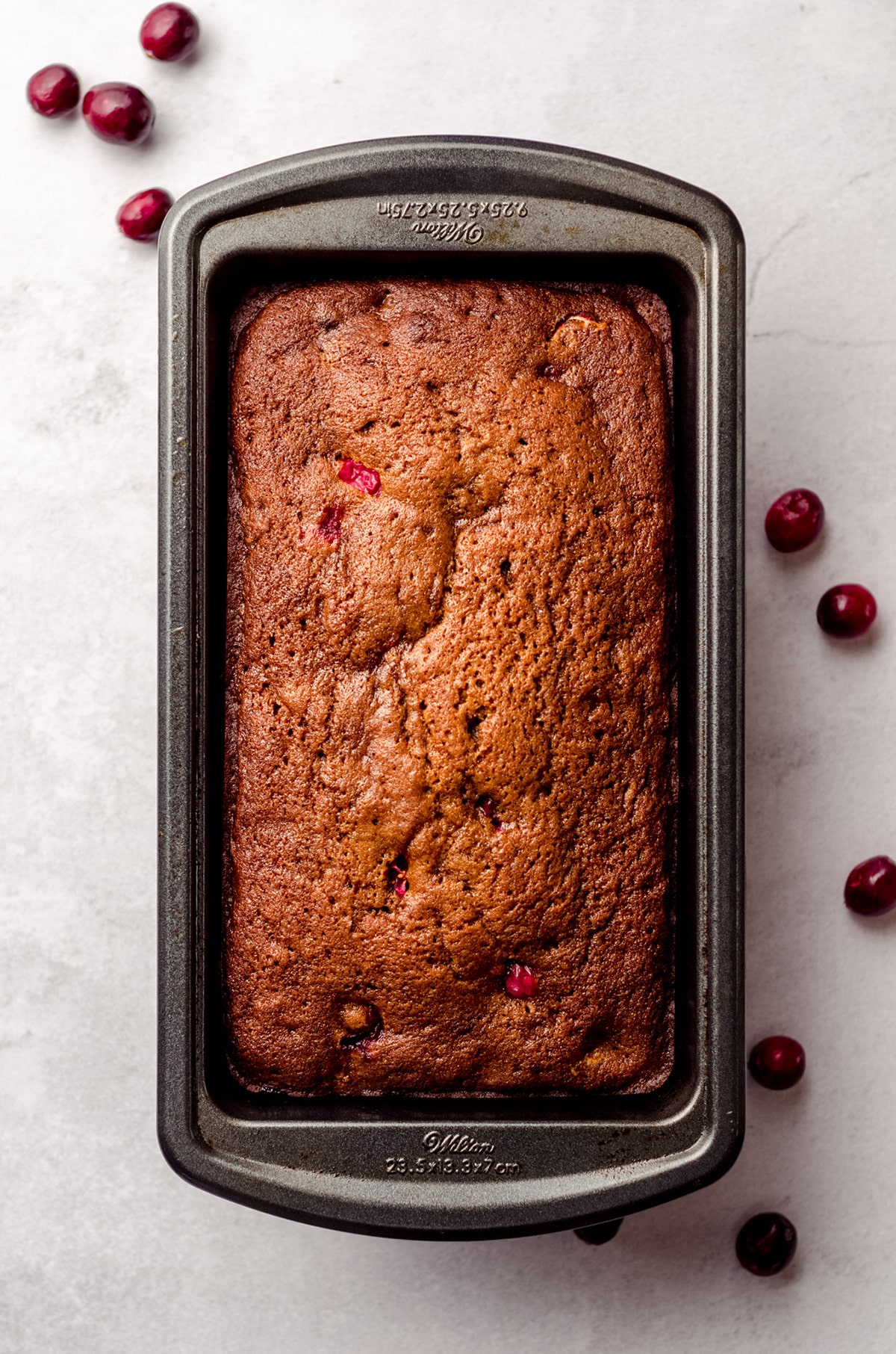 a loaf of cranberry gingerbread in a loaf pan